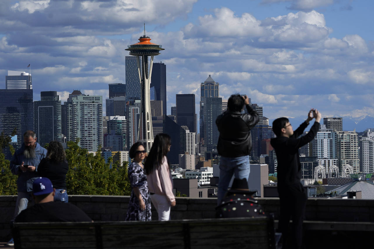 Visitors take in the views of the Space Needle from Kerry Park in Seattle, Tuesday, May 10, 2022. T...