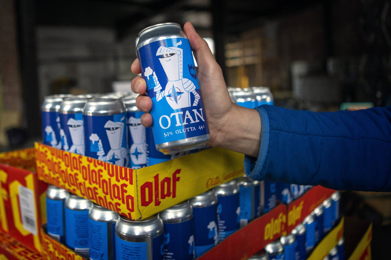 Beer cans with writing OTAN inspired by the North Atlantic Treaty Organization (NATO) logo by Olaf ...