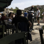 
              People sit at a restaurant with a view at the Acropolis hill, in Athens, on Sunday, May 1, 2022. Italy and Greece relaxed some COVID-19 restrictions on Sunday, in a sign that life was increasingly returning to normal before Europe's peak summer tourist season. (AP Photo/Yorgos Karahalis)
            