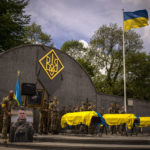 
              Ukrainian soldiers attend the funeral of Melnyk Andriy, Shufryn Andriy and Ankratov Oleksandra, three Ukrainian military servicemen who were killed in the east of the country, in Lviv, Ukraine, Saturday, May 14, 2022. (AP Photo/Emilio Morenatti)
            