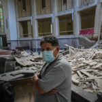 
              Church administrator Alejandro Clemente Gonzalez poses for a photo inside the Calvary Baptist Church damaged by an explosion that devastated the Hotel Saratoga which is located next door, in Old Havana, Cuba, Wednesday, May 11, 2022. Gonzalez was talking with an electrician while preparing for weekend services inside the church when the May 6 explosion shook the building and shattered the 19th century dome towering far above the pews. “I didn't know what was happening," recalls Gonzalez with a trembling voice. “I called on the Lord, ‘What is this, Lord? Help us!’” (AP Photo/Ramon Espinosa)
            