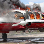 
              FILE - A plane burns after being set on fire by demonstrators protesting increasing violence, at the airport in Les Cayes, Haiti, March 29, 2022. People ran onto the tarmac and torched a small plane owned by a U.S. missionary group. One person died and five others were injured, including four police officers, according to a police official working at the airport. (AP Photo/John Cadafy Noel, File)
            