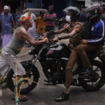 
              A Sri Lankan man pushes back a police motorbike without allowing the same to proceed as protestors demanding supply of essentials block an intersection for the second consecutive day in Colombo, Sri Lanka, Sunday, May 8, 2022. Diplomats and rights groups expressed concern Saturday after Sri Lankan President Gotabaya Rajapaksa declared a state of emergency and police used force against peaceful protesters amid the country's worst economic crisis in recent memory. (AP Photo/Eranga Jayawardena)
            