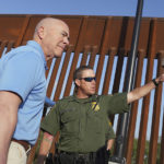 
              Homeland Security Secretary Alejandro Mayorkas, left, listens to Deputy patrol agent in charge of the US Border Patrol Anthony Crane as he tours the section of the border wall Tuesday, May 17, 2022, in Hidalgo, Texas. (Joel Martinez/The Monitor via AP, Pool)
            