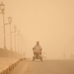 
              A man navigates his wheelchair on a street during a sand storm in Baghdad, Iraq, Monday, May 23, 2022. (AP Photo/Hadi Mizban)
            