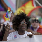 
              Teresa Parks walks in the Little Apple Pride parade Saturday, April 23, 2022, in Manhattan, Kan. Inspired by protests following the death of George Floyd, parks co-founded a Black Lives Matter group and as part of a task force has pushed for more inclusion for people from diverse backgrounds in the predominantly white community. (AP Photo/Charlie Riedel)
            