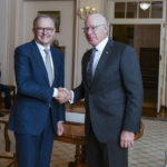 
              Australian Prime Minister Anthony Albanese, left, is congratulated by Australian Governor-General David Hurley, right, after his swearing in ceremony at Government House in Canberra, Monday, May 23, 2022. Albanese has been sworn in ahead of a Tokyo summit while vote counting continues to decide whether he will control a majority in a Parliament that is demanding tougher action on climate change. (Lukas Coch/AAP Image via AP)
            