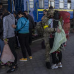 
              Two couples kiss during their reunion after three months of war-related separation at the Kharkiv train station in eastern Ukraine, Friday, May 27, 2022. (AP Photo/Bernat Armangue)
            