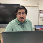 
              Kenneth Bachicha teaches from his empty classroom as his students work remotely from home on video writing about video games in Las Vegas, New Mexico, Monday, May 9, 2022. In Las Vegas, school officials in the district closest to the fire announced Monday afternoon that in-person school would resume Tuesday, with exceptions for children displaced by the flames or health conditions that make them vulnerable to smoke. (AP Photo/Cedar Attanasio)
            