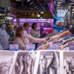
              A customer pays for fish at the Maravillas market in Madrid, Thursday, May 12, 2022. Russia's war in Ukraine has accelerated inflation across Europe, with prices for energy, materials and food surging at rates not seen for decades. Inflation is expected to hit nearly 7% this year in the 27-nation EU and is contributing to slowing growth forecasts. (AP Photo/Manu Fernandez)
            