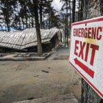 
              Twisted metal roofing and ashes remain of the Pendaries Village & Golf Resort restaurant and clubhouse in the evacuation area near Mora, N.M., Wednesday, May 4, 2022, where firefighters have been battling the Hermit's Peak and Calf Canyon fire for weeks. Weather conditions described as potentially historic are on tap for New Mexico on Saturday, May 7, and over the next several days as the largest fire burning in the U.S. chews through more tinder-dry mountainsides. (Jim Weber/Santa Fe New Mexican via AP)
            