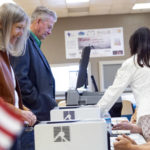 
              Idaho Gov. Brad Little and First Lady Teresa Little check in with poll workers before casting their ballots in Idaho's Primary Election in Emmett, Idaho, Tuesday, May 17, 2022. (AP Photo/Kyle Green)
            