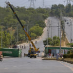 
              Authorities place shipping containers to block a road leading to capital city in an attempt to foil a planned rally, in Islamabad, Pakistan, Wednesday, May 25, 2022. Pakistani authorities blocked off all major roads into the capital Islamabad on Wednesday, after a defiant former Prime Minister Imran Khan said he would march with demonstrators to the city center for a rally he hopes will bring down the government and force early elections.(AP Photo/Anjum Naveed)
            