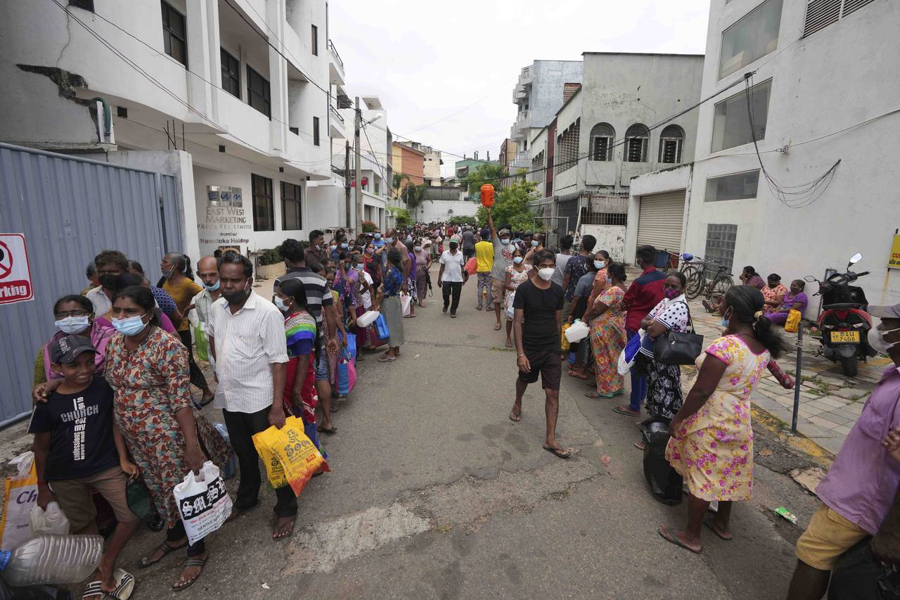 FILE - Sri Lankans queue up near a fuel station to buy kerosene in Colombo, Sri Lanka, Tuesday, Apr...