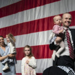 
              GOP attorney general candidate Jim Schultz leaves the stage with his wife Molly and their children during the first day of the Minnesota State Republican Convention, Friday, May 13, 2022,  at the Mayo Civic Center in. Rochester, Minn. (Glen Stubbe/Star Tribune via AP)
            