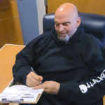 
              In this photo provided by campaign staffer Bobby Maggio, Pennsylvania Lt. Governor and Democratic Party candidate for a U.S. Senate John Fetterman fills out his emergency absentee ballot for the Pennsylvania primary election in Penn Medicine Lancaster General Hospital in Lancaster, Pa, on Election Day, Tuesday, May, 17, 2022. Fetterman remained in the hospital after suffering a stroke right before the weekend. (Bobby Maggio via AP)
            