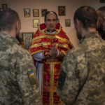 
              Ukrainian Army chaplain Vasyl talks to Ukrainian serviceman after a Sunday mass at a Ukrainian Orthodox church in Kharkiv, eastern Ukraine, Sunday, May 29, 2022. (AP Photo/Bernat Armangue)
            