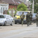 
              Servicemen of Donetsk People's Republic militia walk in Mariupol, in territory under the government of the Donetsk People's Republic, eastern Ukraine, Tuesday, May 17, 2022. (AP Photo/Alexei Alexandrov)
            