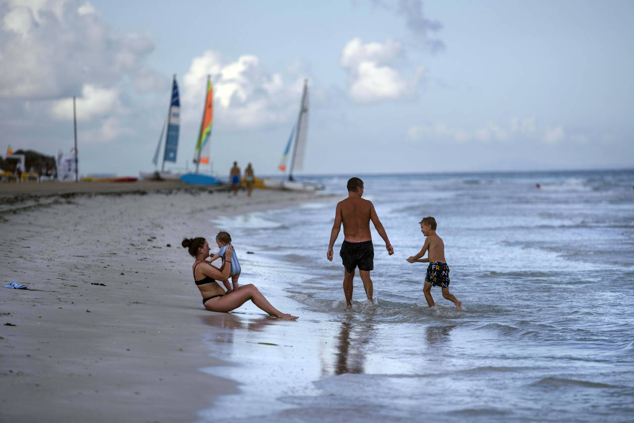 FILE - Tourists are seen along the beach at the Iberostar Selection Varadero hotel in Varadero, Cub...