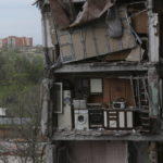 
              A part of an apartment is seen at the side of damaged during a heavy fighting buildings in Mariupol, in territory under the government of the Donetsk People's Republic, eastern Ukraine, Thursday, May 13, 2022. (AP Photo)
            