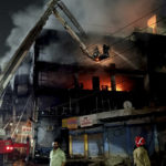 
              Fire officials try to douse a fire in a four storied building, in New Delhi, India, Friday, May 13, 2022. A massive fire erupted in a four-storied building in the Indian capital on Friday, killing at least 19 people and leaving several injured, the fire control room said. Dozens of people have been rescued from the commercial building, mainly shops, in the Mundka area in the western part of New Delhi. (AP Photo/Dinesh Joshi)
            