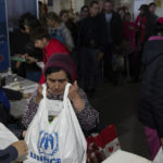 
              A woman receives humanitarian aid at the distribution center for displaced people in Zaporizhia, Ukraine, Thursday, May 5, 2022. (AP Photo/Evgeniy Maloletka)
            