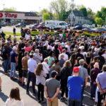 
              People gather outside the scene of a shooting at a supermarket in Buffalo, N.Y., Sunday, May 15, 2022. (AP Photo/Matt Rourke)
            