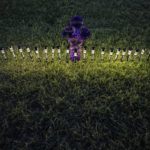 
              Lights illuminate a cross made of flowers at a memorial site in the town square for the victims killed in this week's elementary school shooting on Friday, May 27, 2022, in Uvalde, Texas. (AP Photo/Wong Maye-E)
            