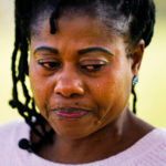 
              Eva Gbaa, whose 17-year-old nephew John "JJ" Gbaa Jr. was killed in a November 2018 hit-and-run as he tried to cross Roosevelt Boulevard, pauses as she speaks during an interview with The Associated Press in Philadelphia, Friday, April 29, 2022. (AP Photo/Matt Rourke)
            