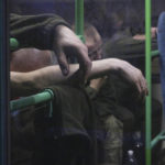 
              Ukrainian servicemen sit in a bus after they were evacuated from the besieged Mariupol's Azovstal steel plant, near a prison in Olyonivka, in territory under the government of the Donetsk People's Republic, eastern Ukraine, Tuesday, May 17, 2022. More than 260 fighters, some severely wounded, were pulled from a steel plant on Monday that is the last redoubt of Ukrainian fighters in the city and transported to two towns controlled by separatists, officials on both sides said. (AP Photo)
            