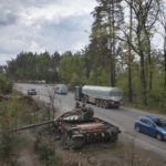 
              Cars pass by Russian tanks destroyed in a recent battle against Ukrainians in the village of Dmytrivka, close to Kyiv, Ukraine, Monday, May 23, 2022. (AP Photo/Efrem Lukatsky)
            