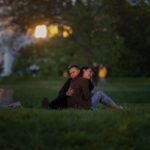 
              Stepan and Anastasia sit at a public park as the sun sets in Kyiv Ukraine on Tuesday, May 10, 2022. (AP Photo/Emilio Morenatti)
            