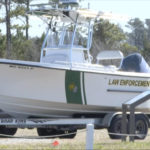 
              FILE - Law enforcement get ready for a search after a small plane crash in Carteret County, N.C., on Monday, Feb. 14, 2022.  The families of four people – including three teens – who died in a February plane crash off the North Carolina coast are suing the companies that owned the plane and employed the pilot, who also died. The suit claims the pilot failed to properly fly the single-engine plane in weather conditions with limited visibility, making the firms liable.   All eight people aboard the Pilatus PC-12/47 died when it descended into the Atlantic Ocean off the Outer Banks. (WCTI-TV via AP, File)
            