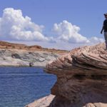 
              FILE - Bill Schneider stands near Antelope Point's public launch ramp on Lake Powell on July 31, 2021, near Page, Ariz., after water levels hit a historic low amid a climate change-fueled megadrought engulfing the U.S. West. Federal water officials have announced that they will keep hundreds of billions of gallons of Colorado River water inside Lake Powell instead of letting it flow downstream to southwestern states and Mexico. U.S. Assistant Secretary of Water and Science Tanya Trujillo said Tuesday, May 3, 2022, that the move would allow the Glen Canyon Dam to continue producing hydropower while officials strategize how to operate the dam with a lower water elevation. (AP Photo/Rick Bowmer, File)
            