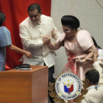 
              Imelda Marcos, widow of the late strongman Ferdinand Marcos, is assisted as she attends the proclamation of her son, Philippine President-elect Ferdinand 'Bongbong" Marcos Jr. at the House of Representatives, Quezon City, Philippines on Wednesday, May 25, 2022. Marcos Jr. was proclaimed the next president of the Philippines by a joint session of Congress Wednesday in an astonishingly huge electoral triumph 36 years after his father was ousted as a brutal dictator by a pro-democracy uprising. (AP Photo/Aaron Favila)
            