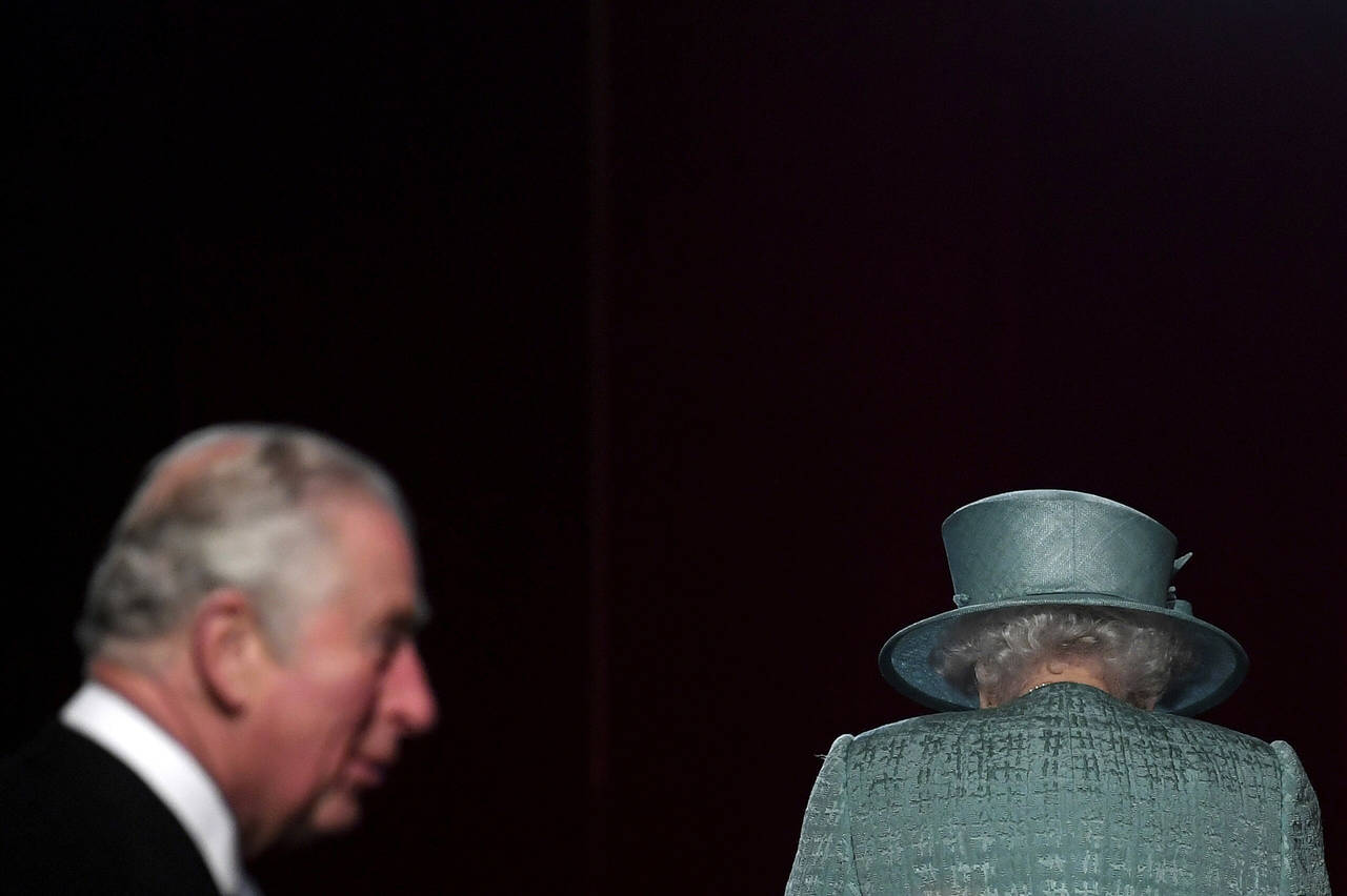FILE - Britain's Queen Elizabeth and Prince Charles arrive for the State Opening of Parliament at t...