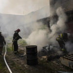 
              Ukrainian firefighters try to extinguish a fire in a warehouse after a Russian strike in Kharkiv, eastern Ukraine, Monday, May 30, 2022. (AP Photo/Bernat Armangue)
            