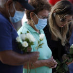 
              People pay their respects at a memorial site for the victims killed in this week's shooting at Robb Elementary School in Uvalde, Texas, Friday, May 27, 2022. (AP Photo/Dario Lopez-Mills)
            