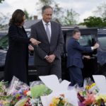 
              Vice President Kamala Harris and her husband Doug Emhoff visit a memorial near the site of the Buffalo supermarket shooting after attending a memorial service for Ruth Whitfield, one of the victims, Saturday, May 28, 2022, in Buffalo, N.Y. (AP Photo/Patrick Semansky)
            