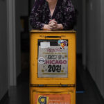 
              Tracy Baim, publisher of the Chicago Reader weekly newspaper stands for a portrait at her office with a weather beaten newspaper box Monday, May 9, 2022, in Chicago. The Reader is expected to become a nonprofit this month after the sale was nearly derailed over co-owner Leonard Goodman's column opposing COVID-19 vaccine requirements for children. Baim said editors asked to hire an independent fact-checker to vet the column. Baim said she and her co-publisher then met with Goodman and discussed options, but "it was very clear he didn't like any" of their proposals. (AP Photo/Charles Rex Arbogast)
            