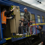 
              People fleeing from shelling board an evacuation train at the  train station, in Pokrovsk, eastern Ukraine, Sunday, May 22, 2022. Civilians fleeing areas near the eastern front in the war in Ukraine Sunday described scenes of devastation as their towns and villages came under attack from Russian forces. (AP Photo/Francisco Seco)
            
