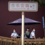 
              Security officers wearing face masks stand at a checkpoint near Tiananmen Square in Beijing, Saturday, June 4, 2022. Saturday marks the anniversary of China’s bloody 1989 crackdown on pro-democracy protests at Beijing’s Tiananmen Square. (AP Photo/Mark Schiefelbein)
            