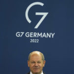 
              FILE - German Chancellor Olaf Scholz attends the presentation of a special stamp of the German mail service Deutsche Post for the upcoming G-7 summit, at the chancellery in Berlin, Germany, June 15, 2022. At this year's G-7 summit, Germany will push its plan for countries to join together in a ‘climate club' to tackle global warming. Members of the club would agree on ambitious emissions targets and exempt each other from climate-related trade tariffs.  (AP Photo/Markus Schreiber, File)
            