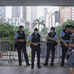 
              Police officers stand guard near the Convention and Exhibition Center, where Chinese President Xi Jinping will attend an inauguration ceremony for the new, sixth term government in Hong Kong, Friday, July 1, 2022. Hong Kong’s incoming and outgoing leaders attended a flag-raising ceremony Friday marking the 25th anniversary of the return to Chinese rule for the city pulled in recent years under much tighter Communist Party control. 
(AP Photo/Harry Long)
            
