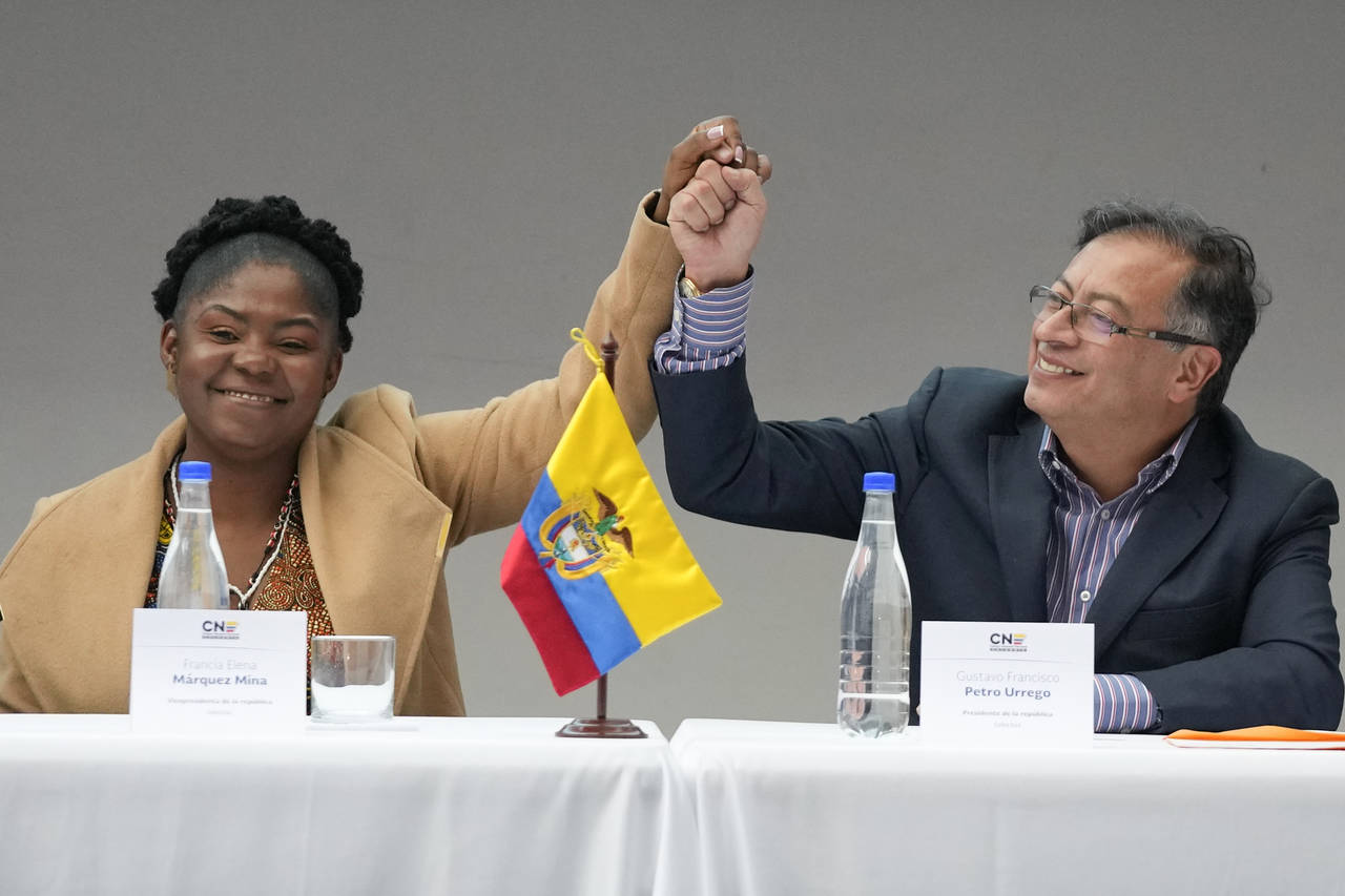 Colombian President-elect Gustavo Petro, right, and running mate Francia Marquez, join hands during...