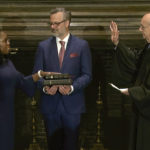 
              In this image from video provided by the Supreme Court, retired Supreme Court Associate Justice Stephen Breyer administers the Judicial Oath to Ketanji Brown Jackson as her husband Patrick Jackson holds the Bible at the Supreme Court in Washington, Thursday, June 30, 2022. (Supreme Court via AP)
            