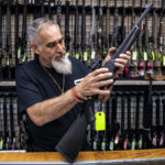 
              Salesman John Licata demonstrates a competition shooting gun at SP firearms on Thursday, June 23, 2022, in Hempstead, New York. (AP Photo/Brittainy Newman)
            