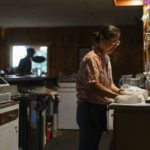 
              Yokie Johnson prepares a takeout order at the restaurant she owns with her husband in Fishtail, Mont., Friday, June 17, 2022. The main road into Fishtail was washed away by the recent floodwaters and Johnson worries the lack of traffic will hurt their business. For Johnson, the business was a dream come true. She had beat cancer a few years ago, but it returned late last year in a more aggressive form and has spread across her body. "I'm not sure how much time I have left, so the time I have left I want to be with my family, work with them every day, see them every day," she said. (AP Photo/David Goldman)
            