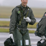 
              FILE  Britain's Prince William gestures as he walks across the airfield at RAF Cranwell, Lincolnshire, England, Thursday, Jan. 17, 2008. The world watched as Prince William grew from a towheaded schoolboy to a dashing air-sea rescue pilot to a father of three. But as he turns 40 on Tuesday, June 21, 2022, William is making the biggest change yet: assuming an increasingly central role in the royal family as he prepares for his eventual accession to the throne.  (AP Photo/Kirsty Wigglesworth, File)
            