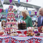 
              Britain's Prince Charles, right and Camilla, Duchess of Cornwall, as Patron of the Big Lunch, arrive for the Big Jubilee Lunch with tables set up on the pitch at The Oval cricket ground, on the last of four days of celebrations to mark Queen Elizabeth II's Platinum Jubilee, in London, Sunday, June 5, 2022. (Stefan Rousseau/PA via AP)
            